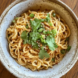 Fiery Garlic Noodles are a culinary gem that tantalizes the taste buds with their bold and robust flavor profile. This dish has gained popularity in recent years due to its quick preparation time and the delightful mix of savory and spicy elements, making it an ideal choice for busy weeknight dinners or a satisfying lunch. Whether you are a seasoned home cook or a novice in the kitchen, this recipe is designed to be accessible and easy to follow, ensuring that anyone can whip up this indulgent meal in no time.